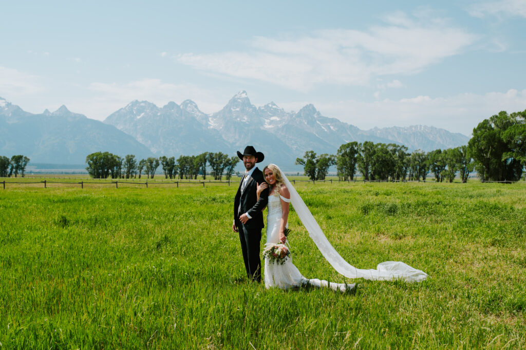 Historic Mormon Row barn in Grand Teton National Park with wide open fields and Teton peaks in the background — rustic Wyoming elopement location.