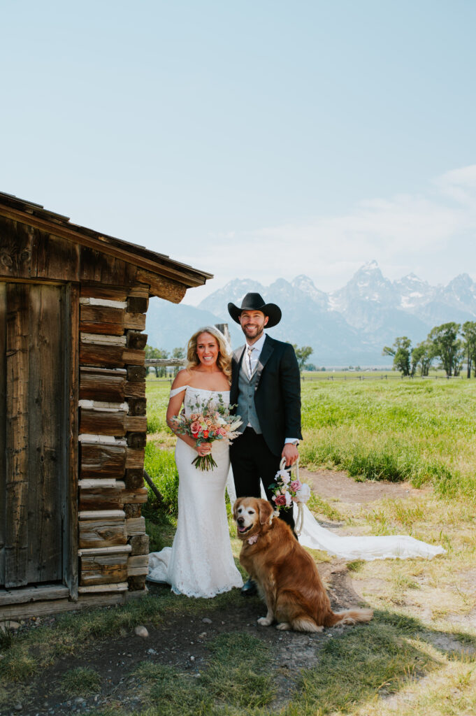 T.A. Moulton Barn on Mormon Row with the Teton mountains glowing behind it at sunrise — iconic historic barn wedding and elopement location.