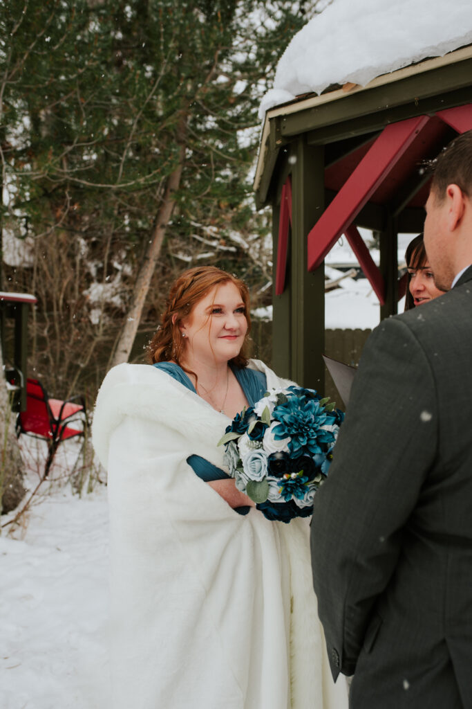 Bride and groom saying vows during peaceful winter Wyoming elopement