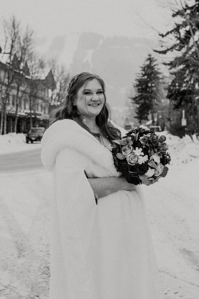 Winter elopement bride portraits in downtown Jackson Hole with snow-covered boardwalks