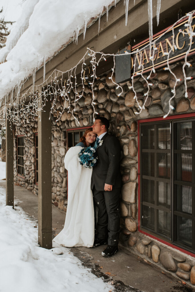 Winter elopement portraits in downtown Jackson Hole with snow-covered boardwalks
