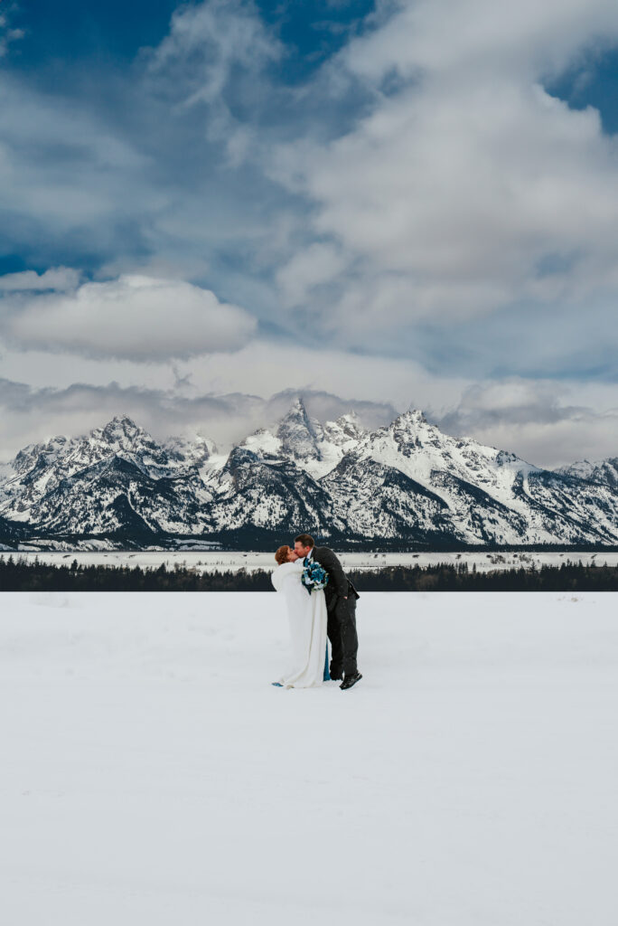 Intimate winter elopement in Grand Teton National Park with dramatic snowy mountain backdrop