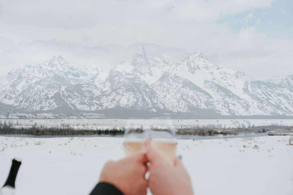 Bride and groom walking through fresh snow during their Tetons winter elopement