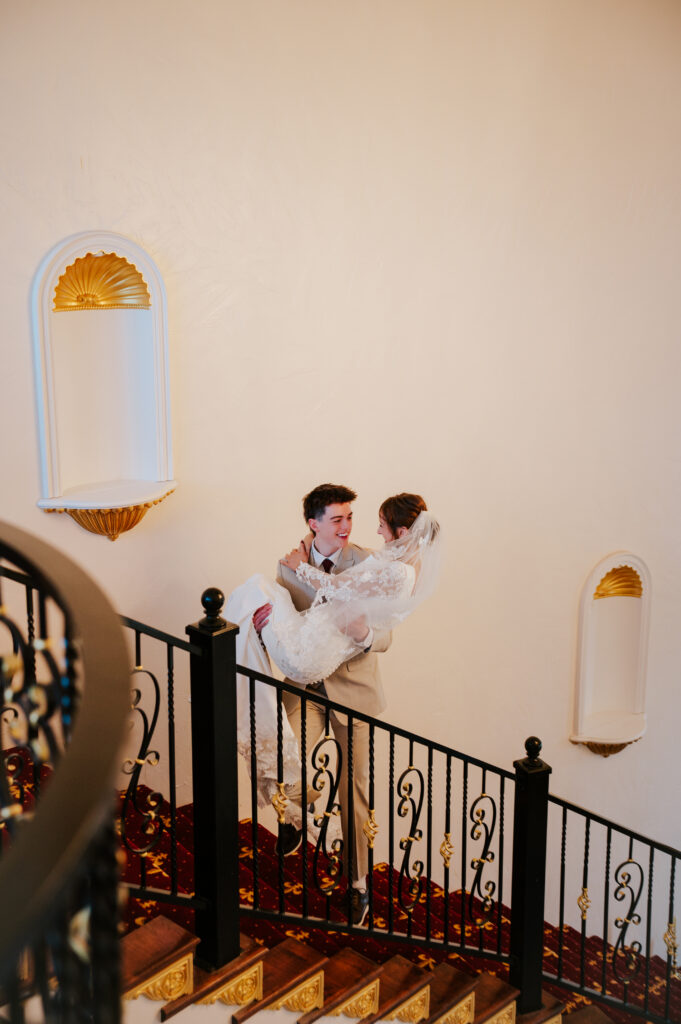 Bride on grand double staircase at Castle Nottingham wedding venue