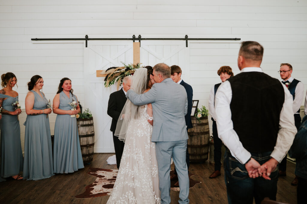 Romantic indoor ceremony at The Barn on 1st wedding venue in Idaho Falls, Idaho