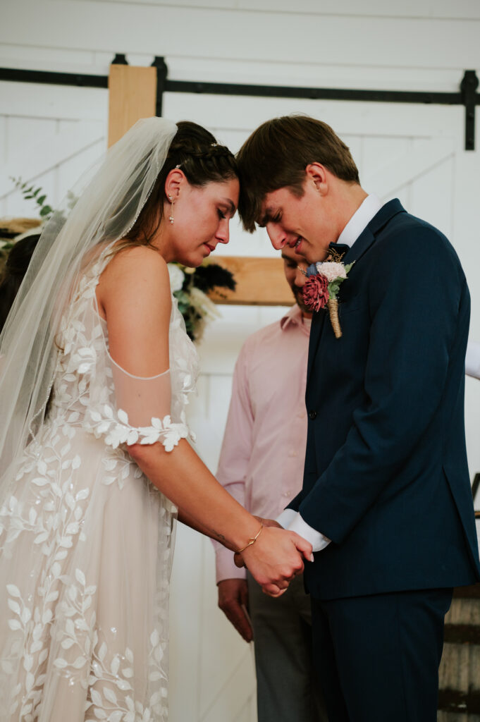 Romantic indoor ceremony at The Barn on 1st wedding venue in Idaho Falls, Idaho