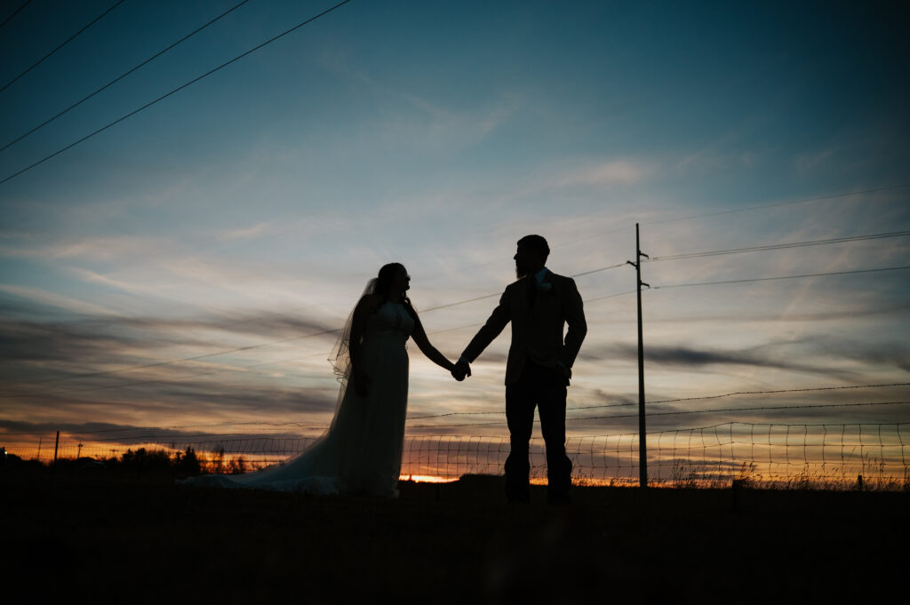 Romantic sunset field portraits at Millhouse Venue Rigby in Rigby Idaho