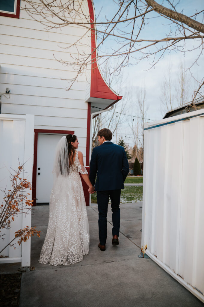Golden hour walking portraits at a Barn on 1st wedding in Idaho Falls with romantic sunset lighting