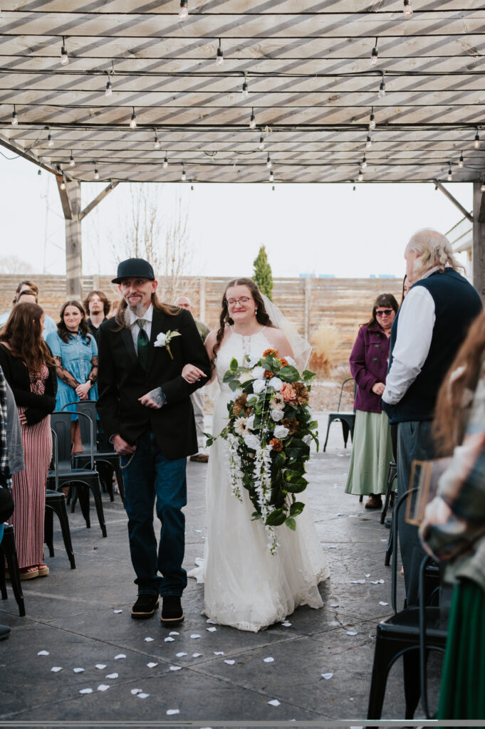 Bride walking down the aisle at Millhouse Venue Rigby wedding ceremony
