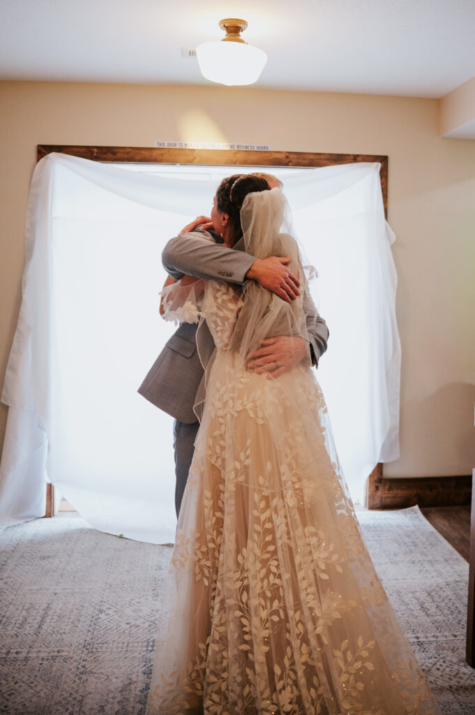 Emotional first look at a Barn on 1st wedding in Idaho Falls captured with timeless photography