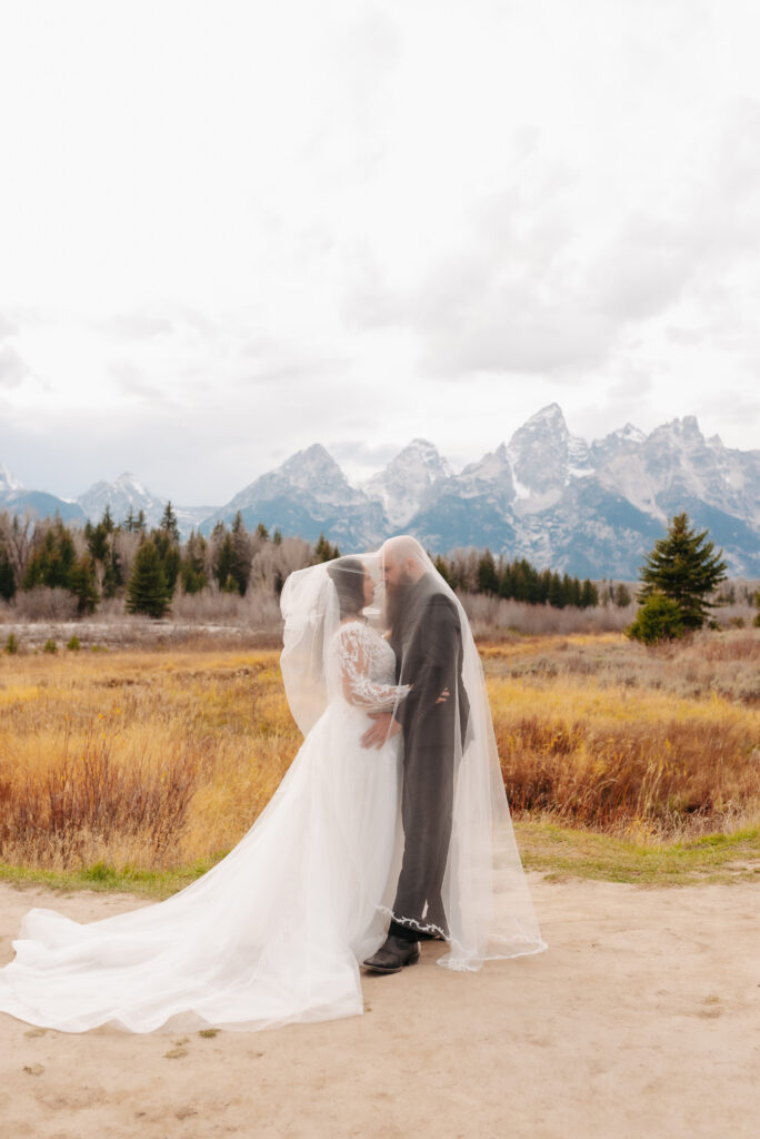 flowy wedding dress wind mountain bridal session Tetons
